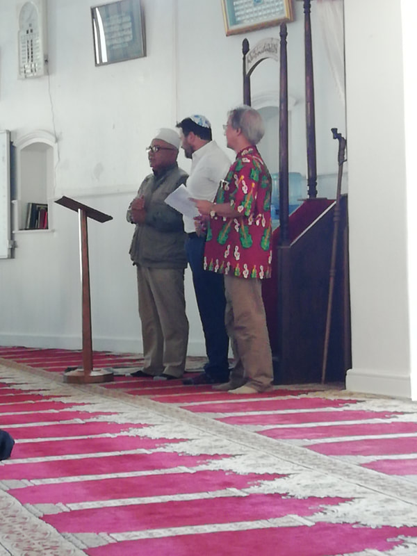 At Al-Azhar Mosque in District 6, Sheikh Ismail Keraan introduces Stuart Diamond of the jewish faith and Bishop Augustine Joemath of the nearby Moravian Church